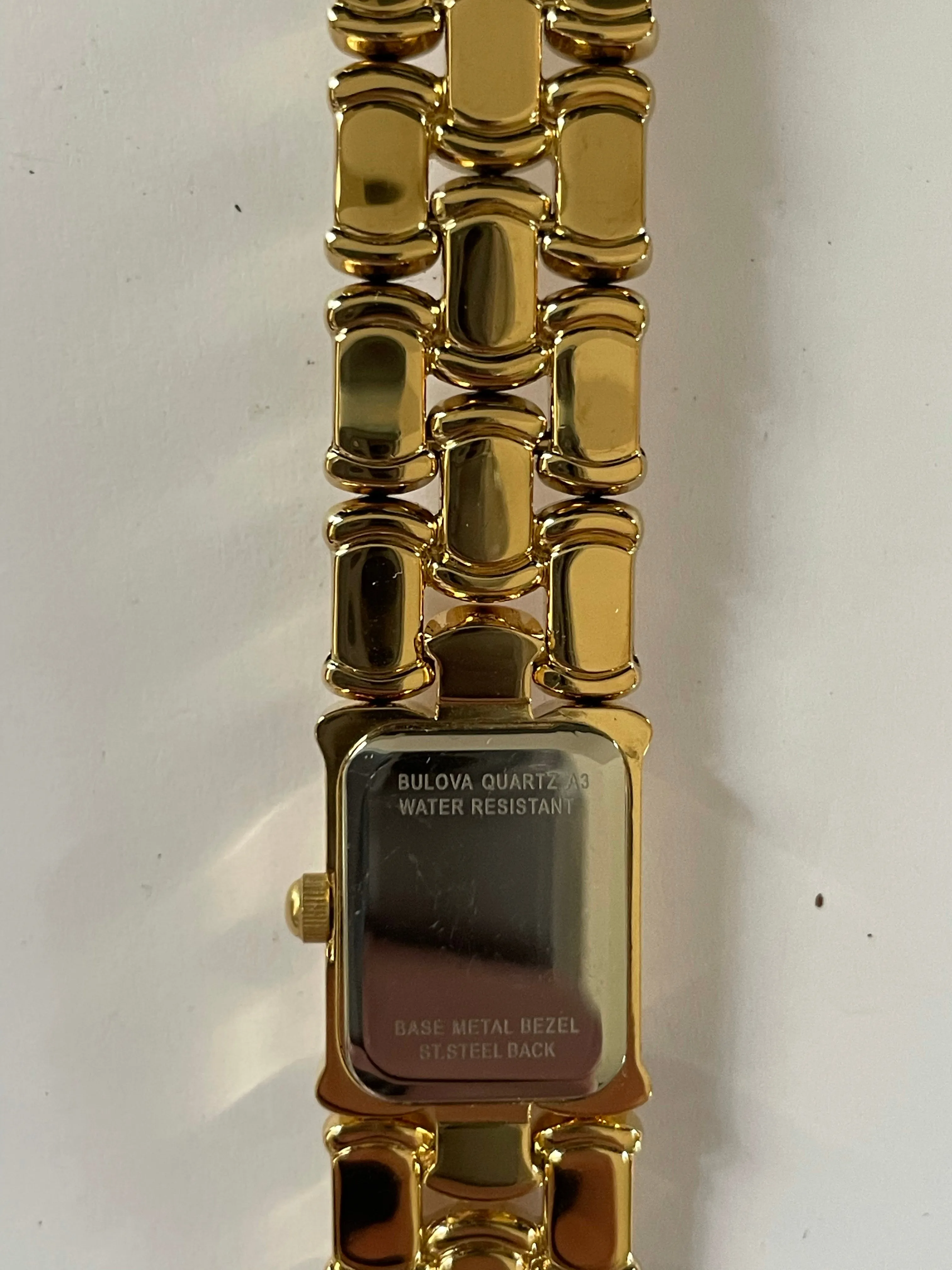 <€€ Ladies BULOVA Gold Tone Watch with Black Dial on Gold Plated Bracelete with Diamond Chip Model 97S86